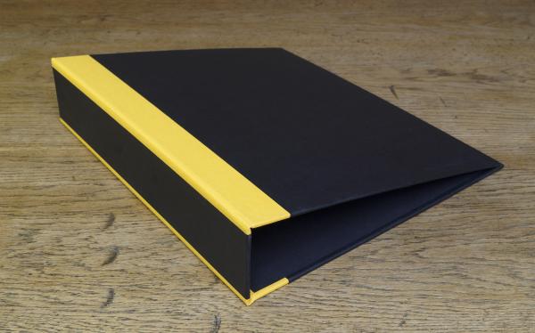 black folder with yellow stripes on the spine